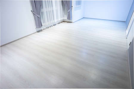 Empty room or bedroom in perspective at night. Interior inside house building with wooden floor or laminate, adjusting vertical or venetian blinds and curtains. New clean look modern for background.の写真素材