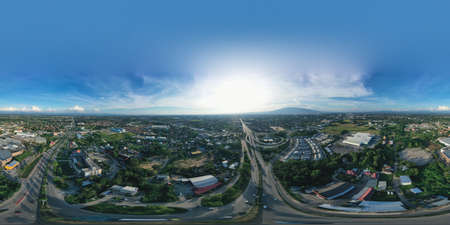 Spherical panorama of landscape of aerial view in Chiang Mai city. That is transportation, highway road and bridge at intersection. Busy with traffic. Include housing estate or residential building.の写真素材