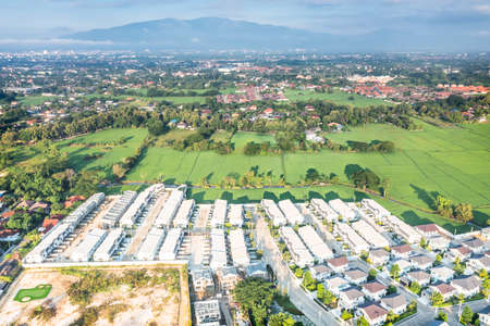 Land or landscape of green field in aerial view. Include agriculture farm, house building, village....