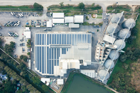 Eco building or factory in aerial view consist of solar or photovoltaic cell in panel on top of...