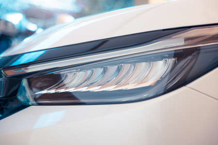 Closeup detail of headlight of auto car consist of led bulb, signal indicator turn light, lamp part, daytime running light. Concept for automotive vehicle, automobile, luxury, polish, clean and wash.の写真素材
