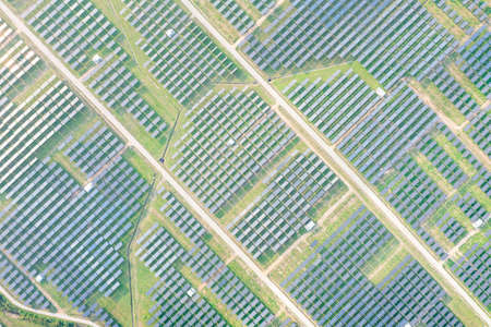 Solar farm, field or solar power plant in aerial view consist of photovoltaic cell in panel, landscape, technology. Industry for electric, electricity generation. Clean green power energy from nature.の写真素材