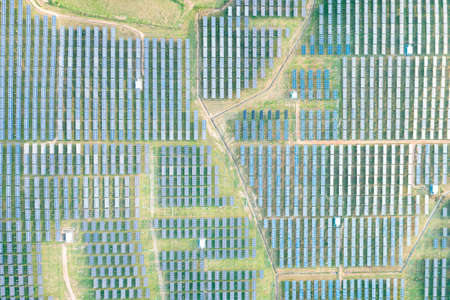 Solar farm, field or solar power plant in aerial view consist of photovoltaic cell in panel, landscape, technology. Industry for electric, electricity generation. Clean green power energy from nature.の写真素材