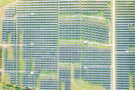 Solar farm, field or solar power plant in aerial view consist of photovoltaic cell in panel, landscape, technology. Industry for electric, electricity generation. Clean green power energy from nature.の写真素材