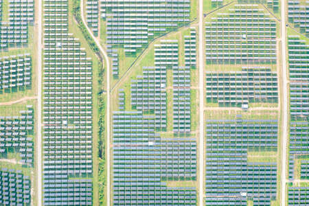 Solar farm, field or solar power plant in aerial view consist of photovoltaic cell in panel,...