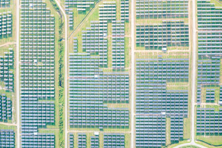 Solar farm, field or solar power plant in aerial view consist of photovoltaic cell in panel, landscape, technology. Industry for electric, electricity generation. Clean green powerの写真素材