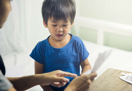 Asian child or kid or little boy to study, learning and play together with mother or mom for...