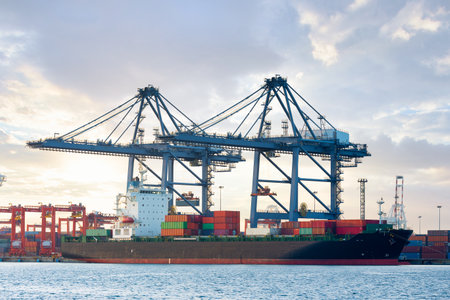 Cargo ship at dock, port or harbor. To loading cargo container, work with crane. Concept of business...