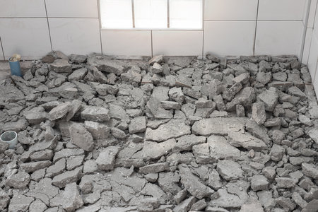 Scrap concrete in toilet room, construction site. Demolished work of tile and concrete floor. To breaking by jack hammer. Cause of bad skill worker. To remove, destruction and re-construction.の写真素材