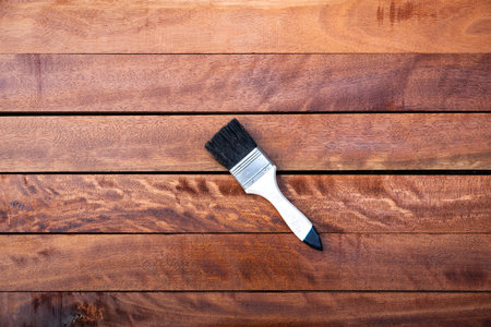 Wood lumber after painting or apply vanish chemical to improve, protective or coating stain grain surface. Look elegance darker brown color. Concept background of woodworking.の写真素材