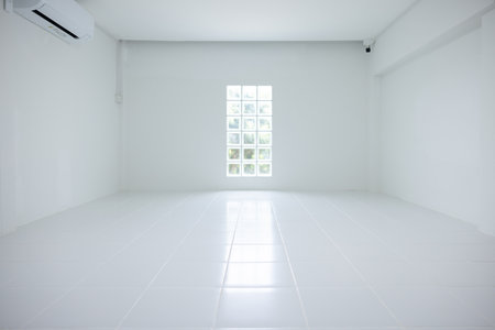 Empty room with square white tile floor texture pattern in perspective at day. Include glass block wall, air conditioner. Clean shiny surface. Modern interior home design.の写真素材