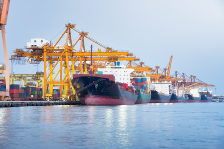 Large crane and cargo ship transport cargo container and docked at port in Bangkok of Thailand....