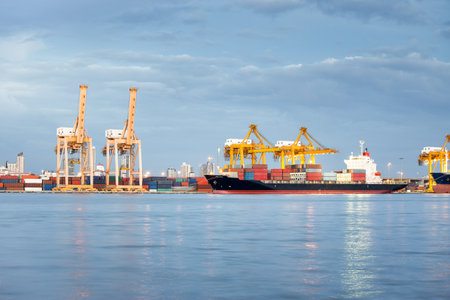 Large crane and cargo ship transport cargo container and docked at port in Bangkok of Thailand....