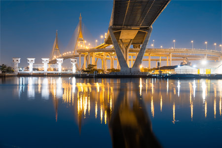 Stunning long exposure captures illuminated architectural beauty of a majestic bridge at twilight in Bangkok City. Showing concrete structure design for support highway road.の写真素材