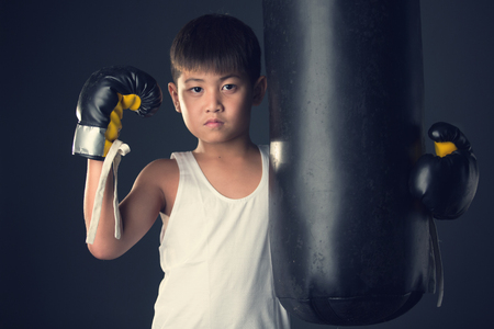 Asian child nearly the heavy bag on vintageの写真素材