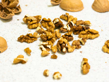 Peeled walnuts and shells are on the table. Artificial stone.の写真素材