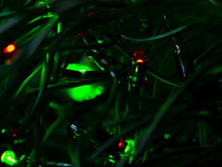 Light bulb, diode shines through the bunch of wires. Green shade. Christmas garland. Technologies.の写真素材