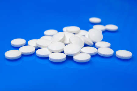 Tablets on a blue background. Many medications.の写真素材