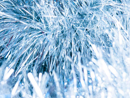 New year, Christmas tinsel. Festive decoration. Macro. Blue background.の写真素材