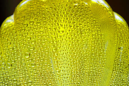 Curly yellow bottle with drops. Condensation on dishes.の写真素材