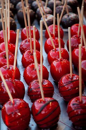 Sweet glazed red toffee candy apples on sticks stock photo stock photoの写真素材