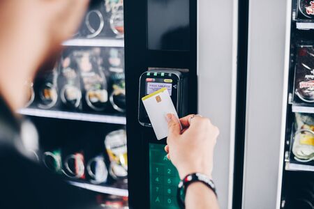 Student using the contactless payment method in a vending machineの写真素材