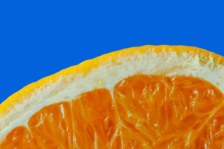 Orange slice on a blue background. Close-up, macro.の写真素材