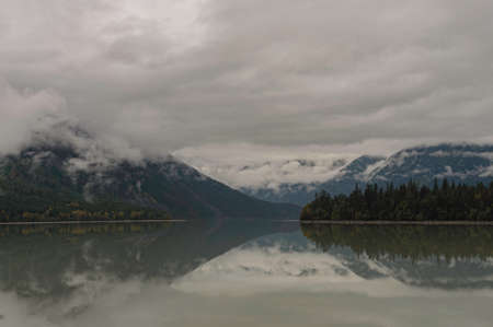 Foggy day over lake and forest