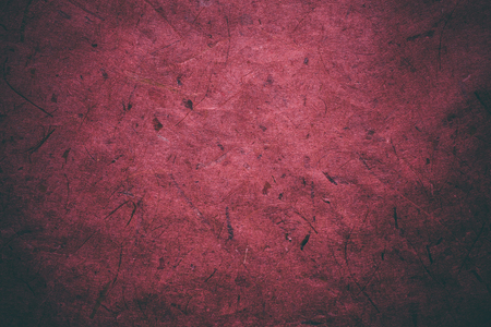 Red grunge texture. Abstract texture and background for designers. Vintage paper background. Rough red texture of recycled paper. Closeup view of abstract red texture. Vintage red paper.の写真素材