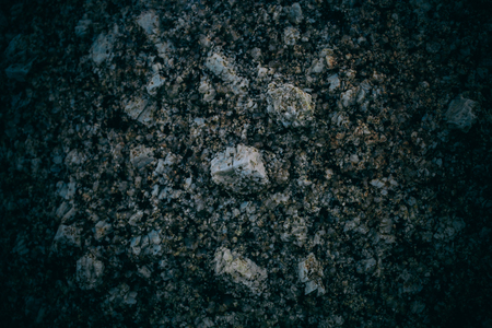 Experimental stone texture and background. Dark rough rock texture. Abstract texture and background for designers. Macro view of dark rough rock floor in vintage style.の写真素材