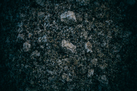 Experimental stone texture and background. Dark rough rock texture. Abstract texture and background for designers. Macro view of dark rough rock floor in vintage style.の写真素材