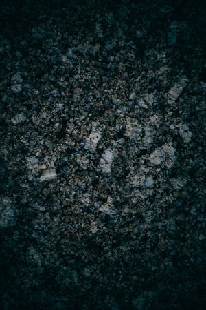 Experimental stone texture and background. Dark rough rock texture. Abstract texture and background for designers. Macro view of dark rough rock floor in vintage style.の写真素材