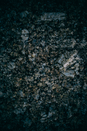 Experimental stone texture and background. Dark rough rock texture. Abstract texture and background for designers. Macro view of dark rough rock floor in vintage style.の写真素材