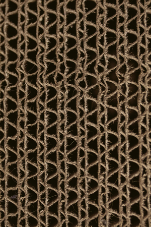 Macro texture of cardboard. Cardboard corrugated pattern. Abstract texture and background for designers. Brown paper texture and pattern. Closeup view of cardboard background.の写真素材