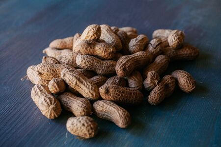 Peanut in shell texture and background. Peanuts texture. Shelled Peanuts. Healthy food. Close up view of shelled peanuts in wooden background. Abstract background and texture for designers.の写真素材