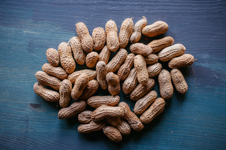 Peanut in shell texture and background. Peanuts texture. Shelled Peanuts. Healthy food. Close up view of shelled peanuts in wooden background. Abstract background and texture for designers.の写真素材
