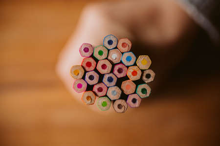 Close up view of colored pencils on wooden background with selective focus. Back to school and education concept. Crayons background for designの写真素材