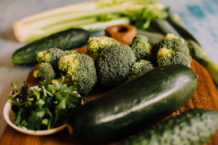 Green vegetables background with broccoli, cucumber, courgette and celery. Healthy, organic and vegan food.の写真素材