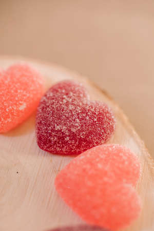 Heart shape jelly sugar candies on wooden background, close up view. Love concept.の写真素材