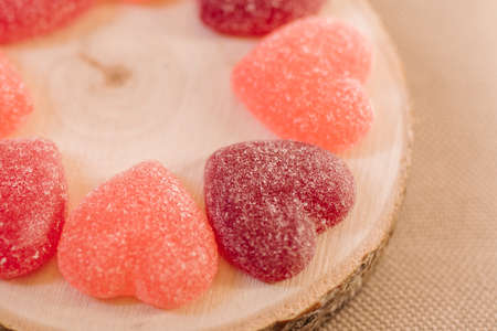 Heart shape jelly sugar candies on wooden background, close up view. Love concept.の写真素材