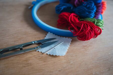embroidery materials on wooden table and grey backgroundの写真素材