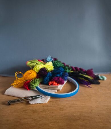 embroidery materials on wooden table and grey backgroundの写真素材
