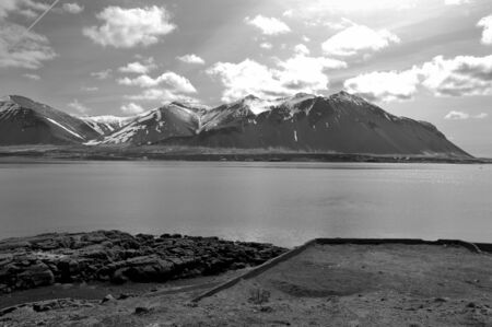 Fjord and snowy mountains with clear sky in wonder Iceland in black and whiteの写真素材