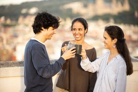 Three brothers making a toast outdoors