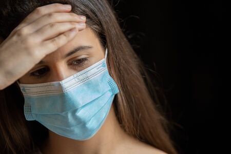 Teen girl with tears with depression symptoms in the darkの写真素材