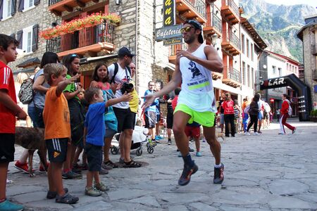 Benasque, Spain - July 26th of 2015: Trail runners pushing hard on their final rush to reach the finish line during one of the five races of the Gran Trail Aneto Posets GTAP of 2015.のeditorial素材