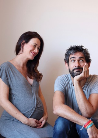 Portrait of a young cheerful pregnant couple.