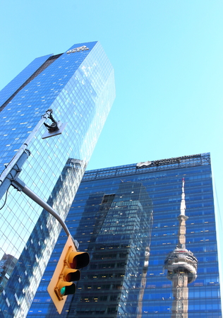 Toronto, Canada - October 19th, 2017: CN Tower reflected in Marsh & McLennan skyscraper with Delta Hotel nearby. This 553.3 m.high building was the world's tallest free-standing structure until 2007.のeditorial素材