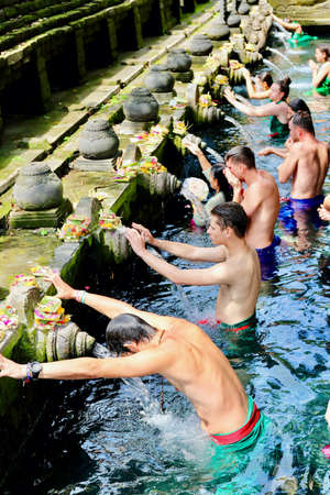 Tirta Empul temple, Tampaksiring, Bali. Locals and tourists going for ritual purification in the holy spring waters of this temple founded around a large water spring in 962 A.D.のeditorial素材