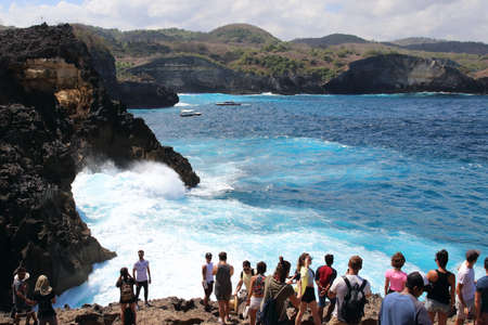 Angelâs Billabong pool, Nusa Penida Island, Indonesia - August 16th of 2019: Tourists waiting their turn to take pictures of this spot where the Indic sea waves hit the cliff close to a rocky pool.のeditorial素材